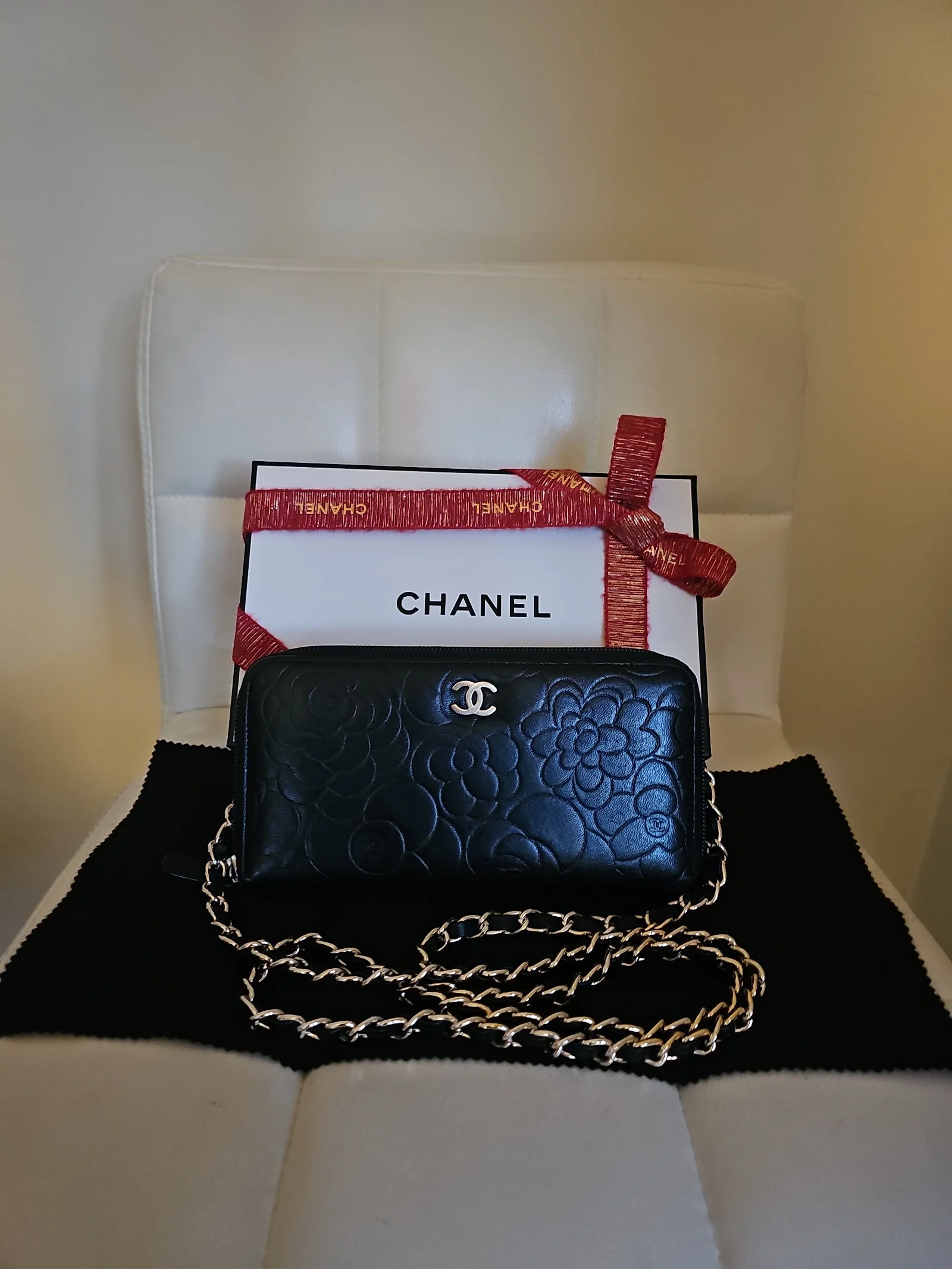 CHANEL Black Lambskin Camellia Embossed Zip Around Wallet